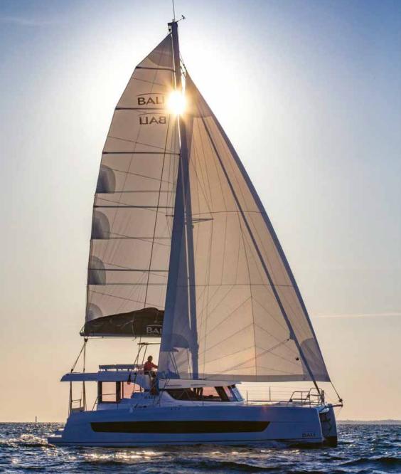 Bali Cat catamaran sailing at golden hour