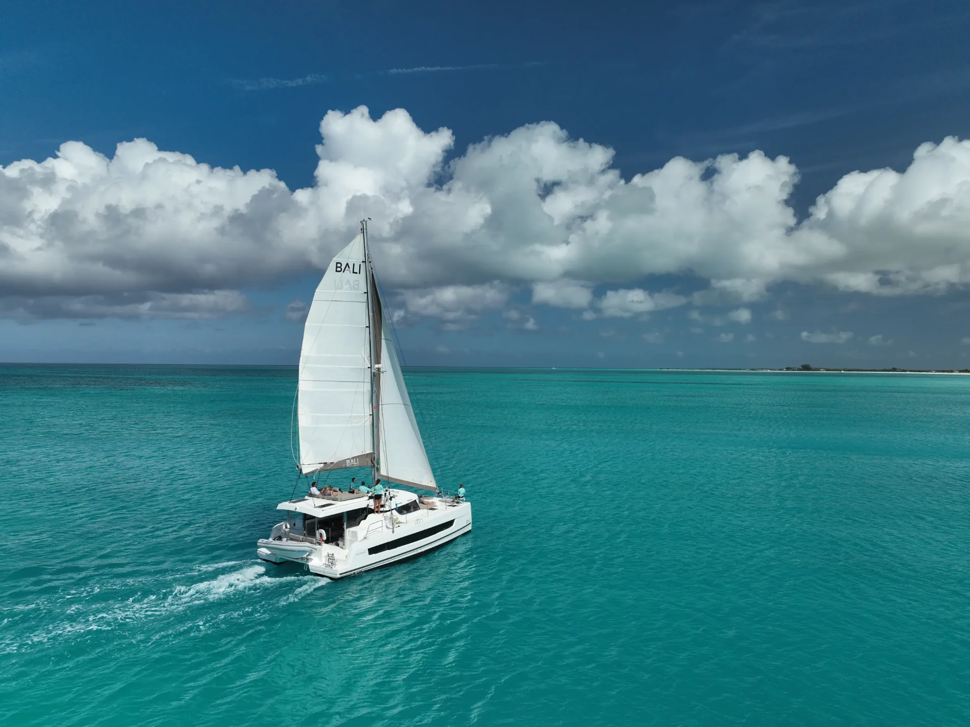 Bali Cat catamaran sailing across turquoise Caicos waters under a bright sky